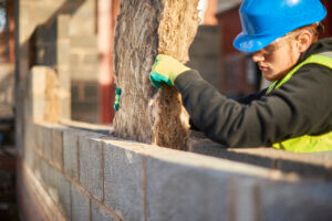 Man installing cavity wall insulation